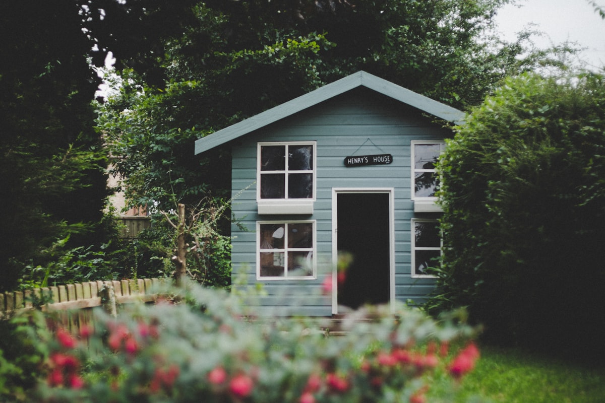 Custom-built backyard office shed with matched siding and windows