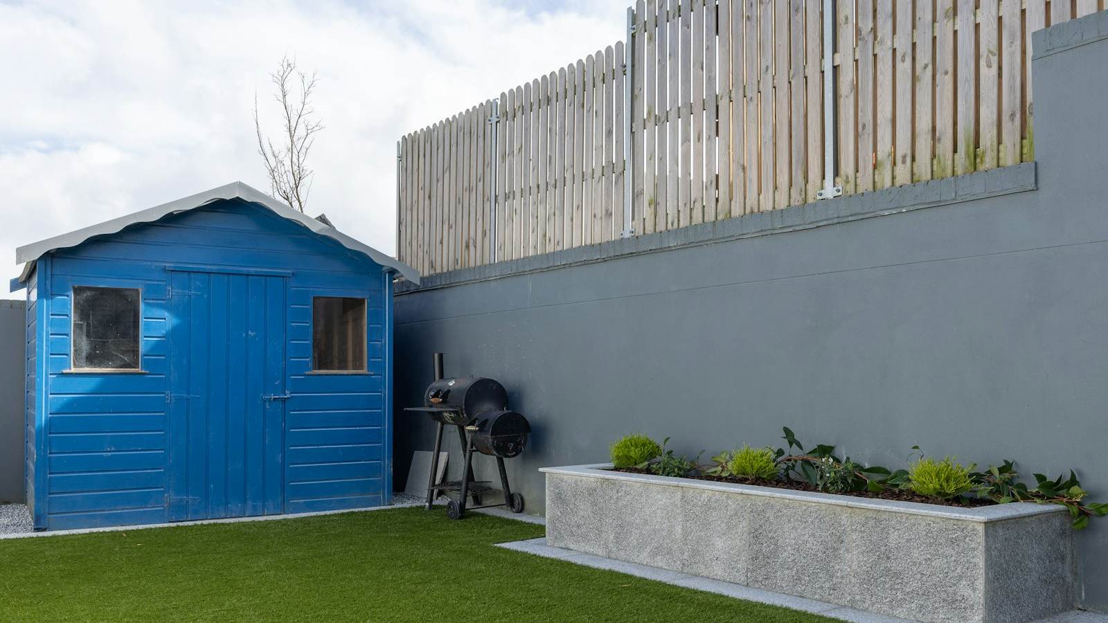Blue backyard storage shed available through a rent-to-own program